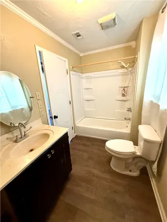 a bathroom with a sink vanity mirror and toilet