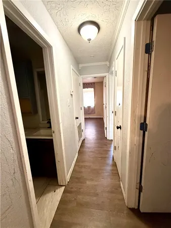 a view of a hallway with wooden floor and staircase