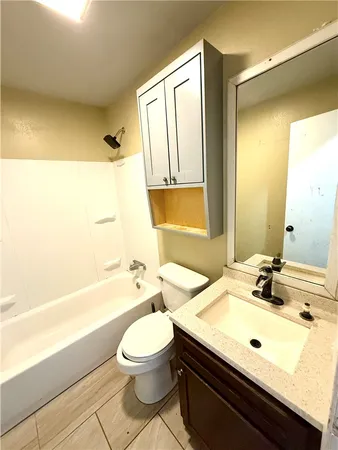 a bathroom with a sink a toilet and bathtub