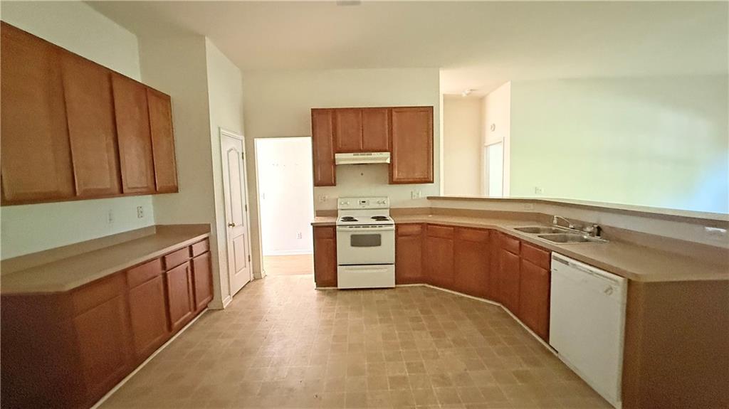65 Lakeridge Court Covington, GA 30016 - Photo 8 of 17 a kitchen with stainless steel appliances a stove sink and cabinets