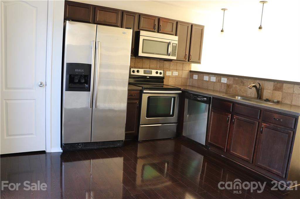 718 Elders Story Road Fort Mill, SC 29708 - Photo 3 of 13 a kitchen with granite countertop a refrigerator and a sink