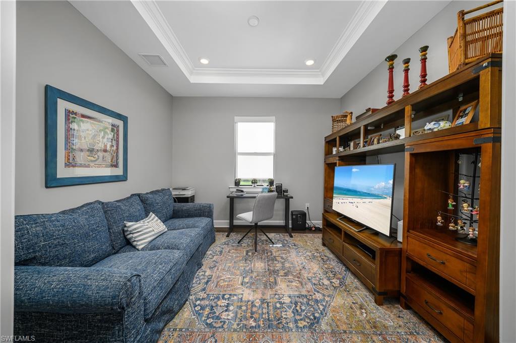 17574 Ashcomb Way Estero, FL 33928 - Photo 11 of 32 a living room with furniture and a flat screen tv