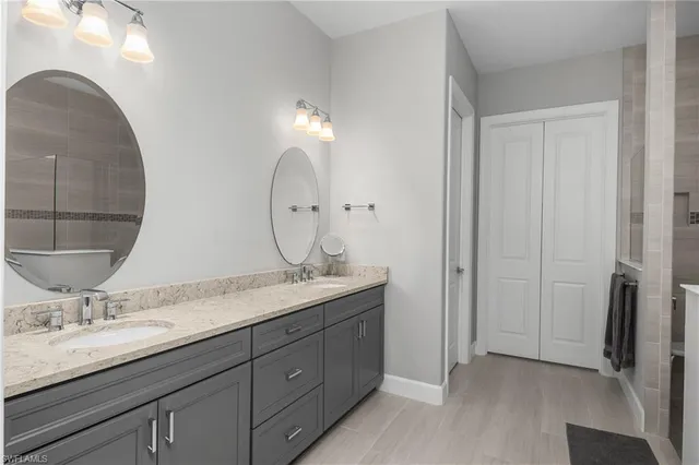 a bathroom with a double vanity sink and mirror