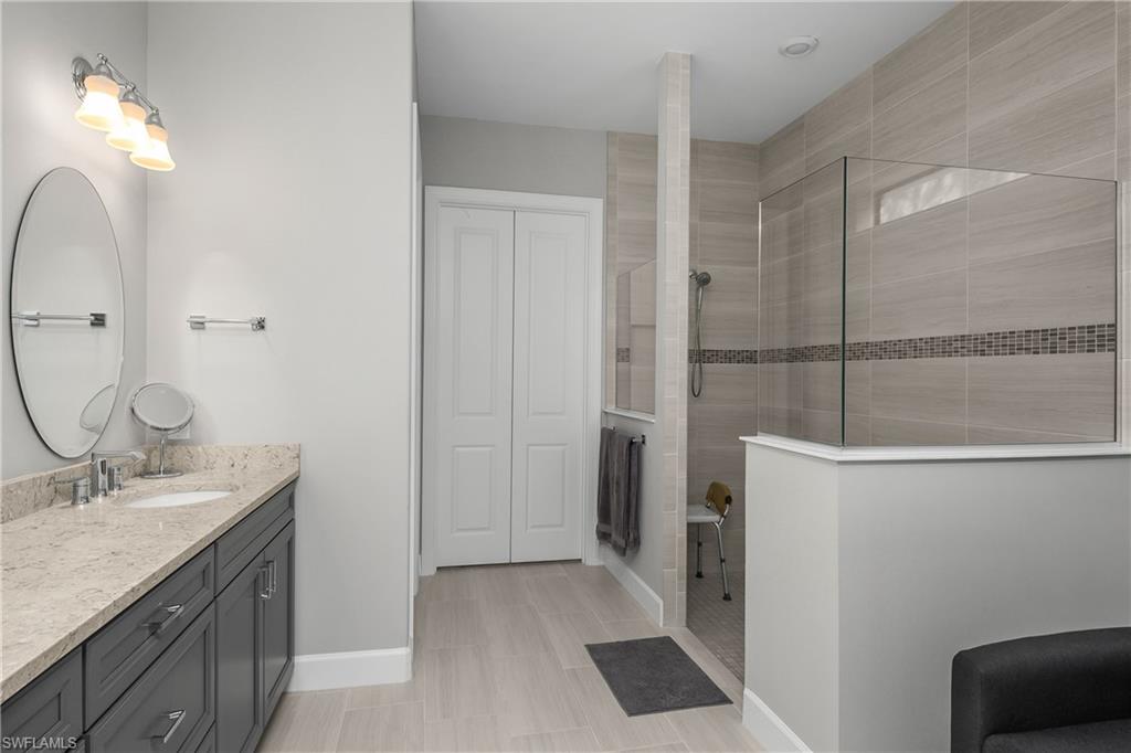 17574 Ashcomb Way Estero, FL 33928 - Photo 15 of 32 a bathroom with a sink and a mirror