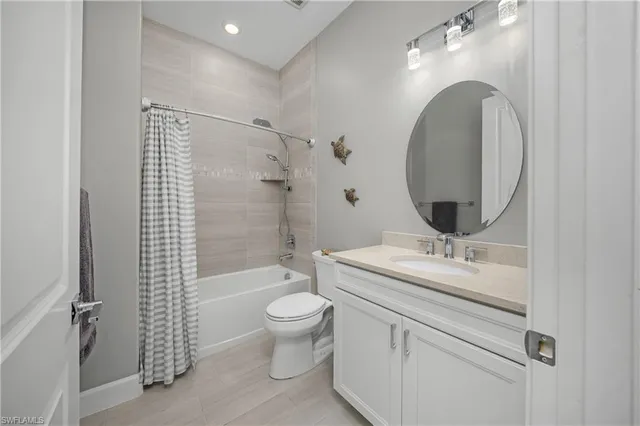 a bathroom with a granite countertop toilet a sink and a mirror