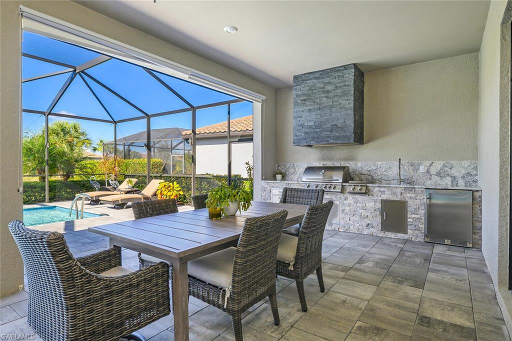 17574 Ashcomb Way Estero, FL 33928 - Photo 22 of 32 a outdoor dining space with furniture and outdoor view