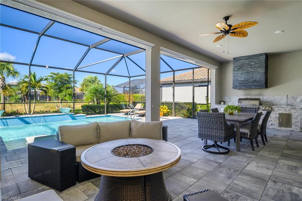 17574 Ashcomb Way Estero, FL 33928 - Photo 23 of 32 a dining room with furniture and a floor to ceiling window