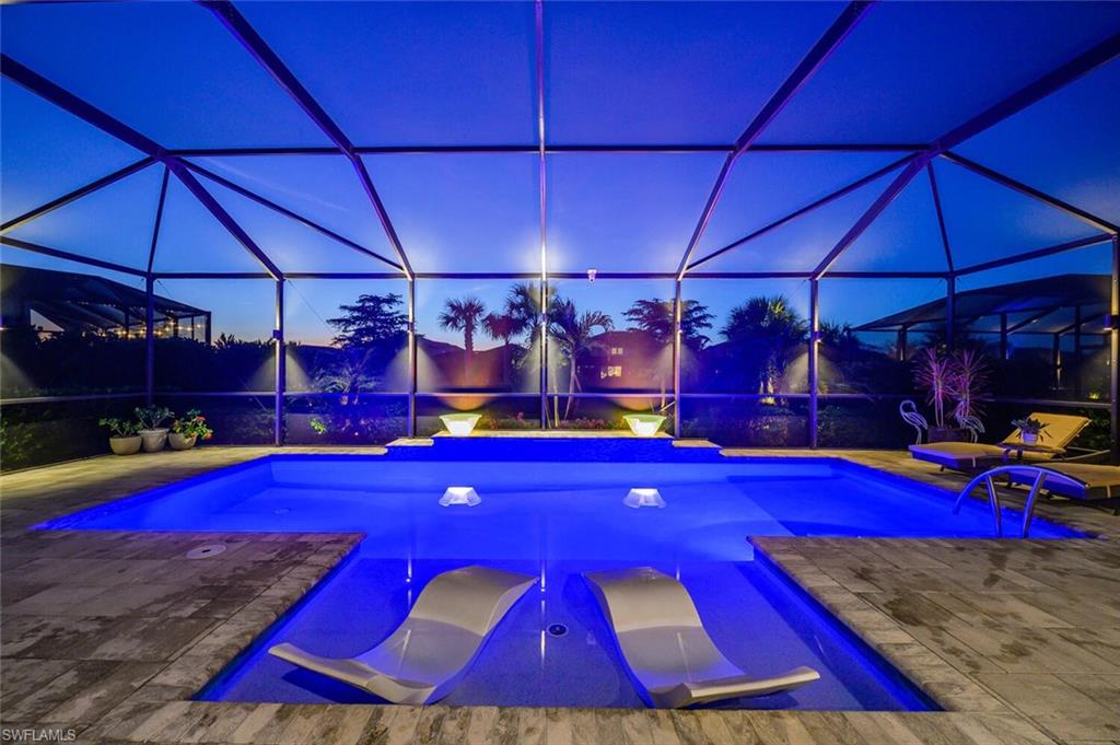 17574 Ashcomb Way Estero, FL 33928 - Photo 26 of 32 a view of swimming pool with red chairs under an umbrella