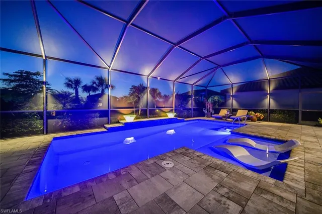 a view of swimming pool with red umbrella