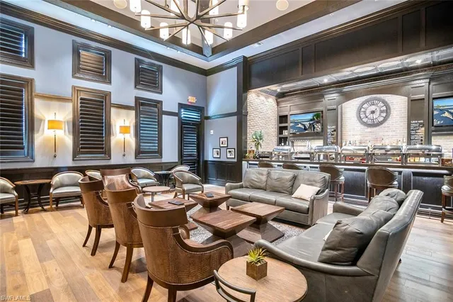 a dining room with furniture and a large window