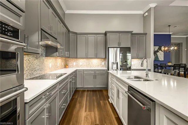 a kitchen with a sink and refrigerator