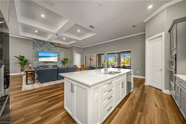 a large kitchen with stainless steel appliances a lot of counter space and wooden floor