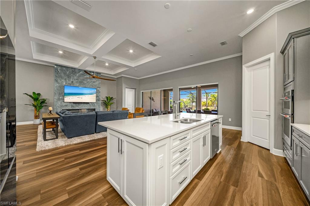 17574 Ashcomb Way Estero, FL 33928 - Photo 8 of 32 a large kitchen with stainless steel appliances a lot of counter space and wooden floor