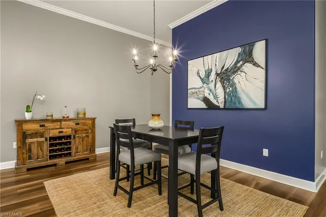a view of a dining room with furniture and chandelier