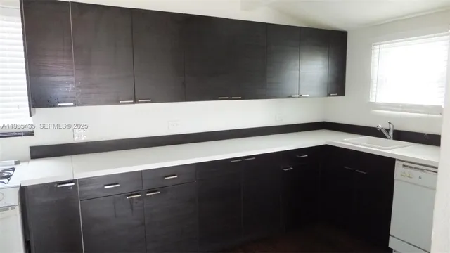 a kitchen with a sink and a mirror