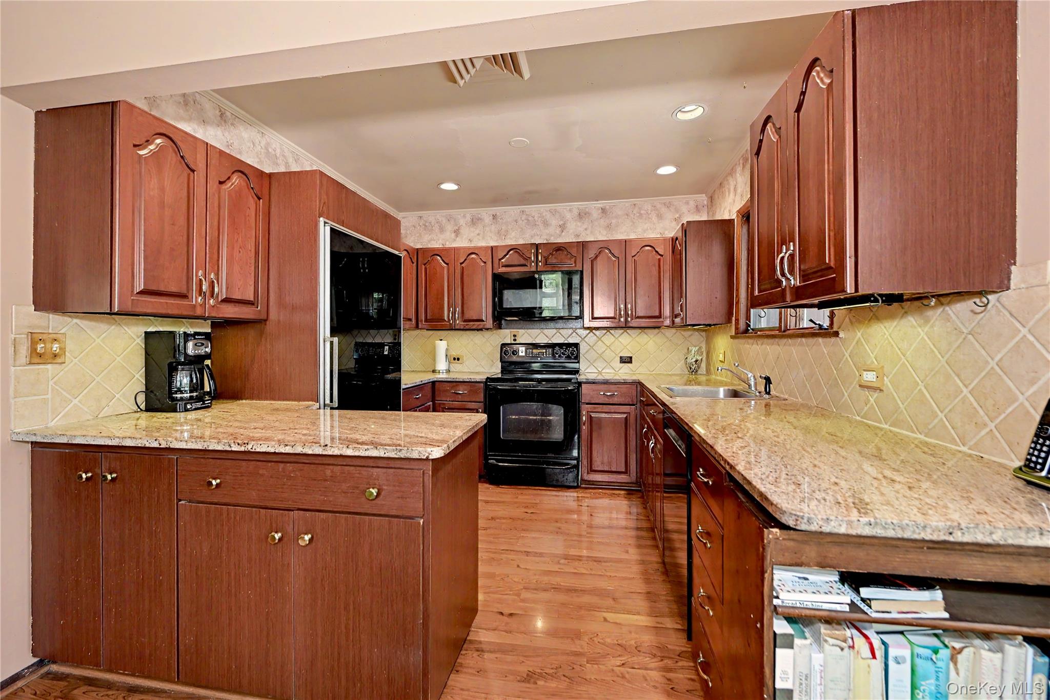 631 Croton Falls Road Carmel, NY 10512 - Photo 7 of 43 a kitchen with stainless steel appliances granite countertop wooden cabinets a sink and a stove