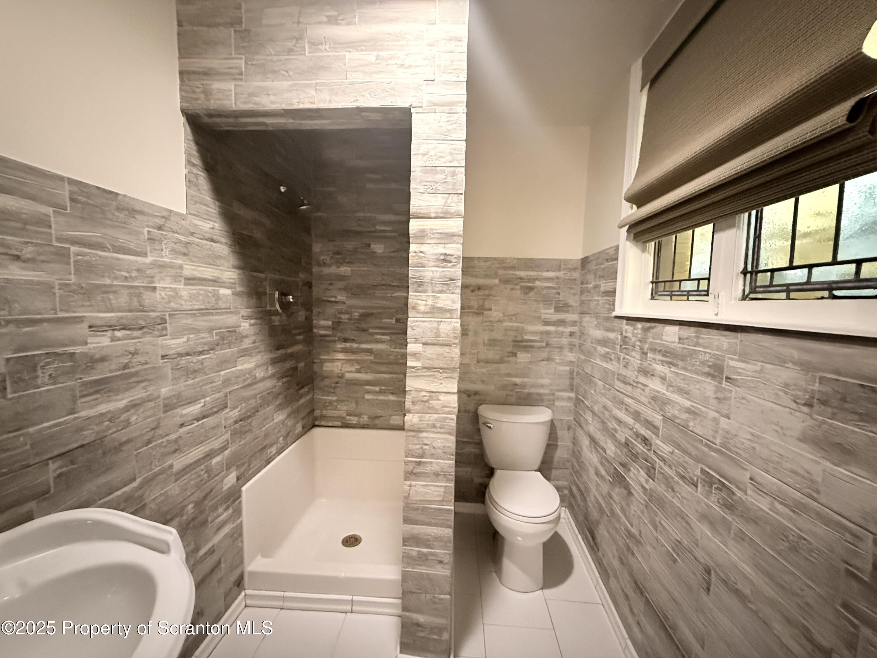 629 Clay Avenue, Unit 1 Scranton, PA 18510 - Photo 11 of 15 a bathroom with a toilet and a shower