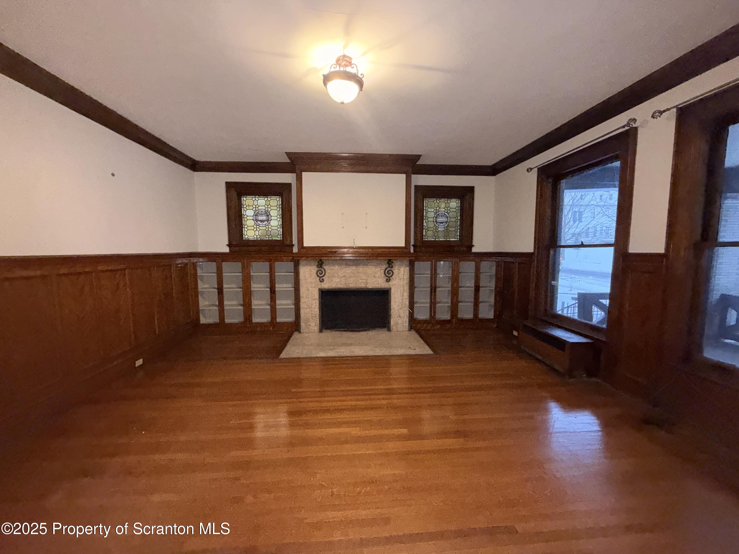 629 Clay Avenue, Unit 1 Scranton, PA 18510 - Photo 3 of 15 a view of livingroom with furniture fireplace and window