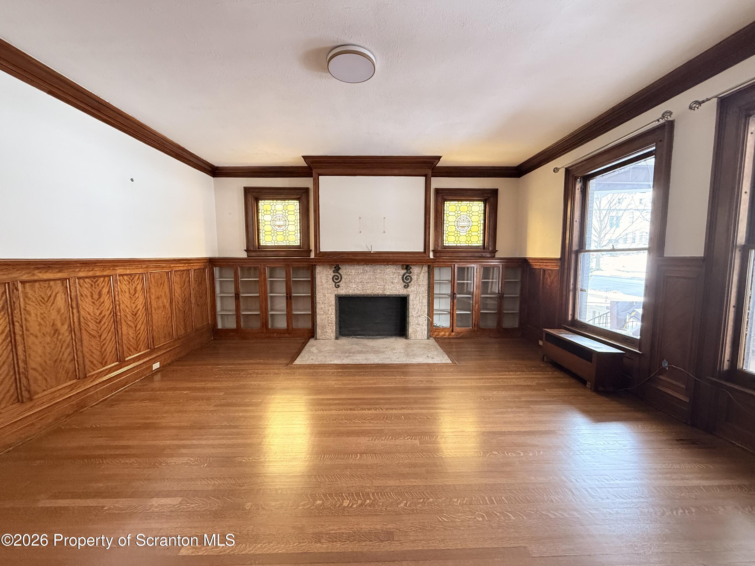 629 Clay Avenue, Unit 1 Scranton, PA 18510 - Photo 3 of 15 a view of empty room with fireplace and wooden floor