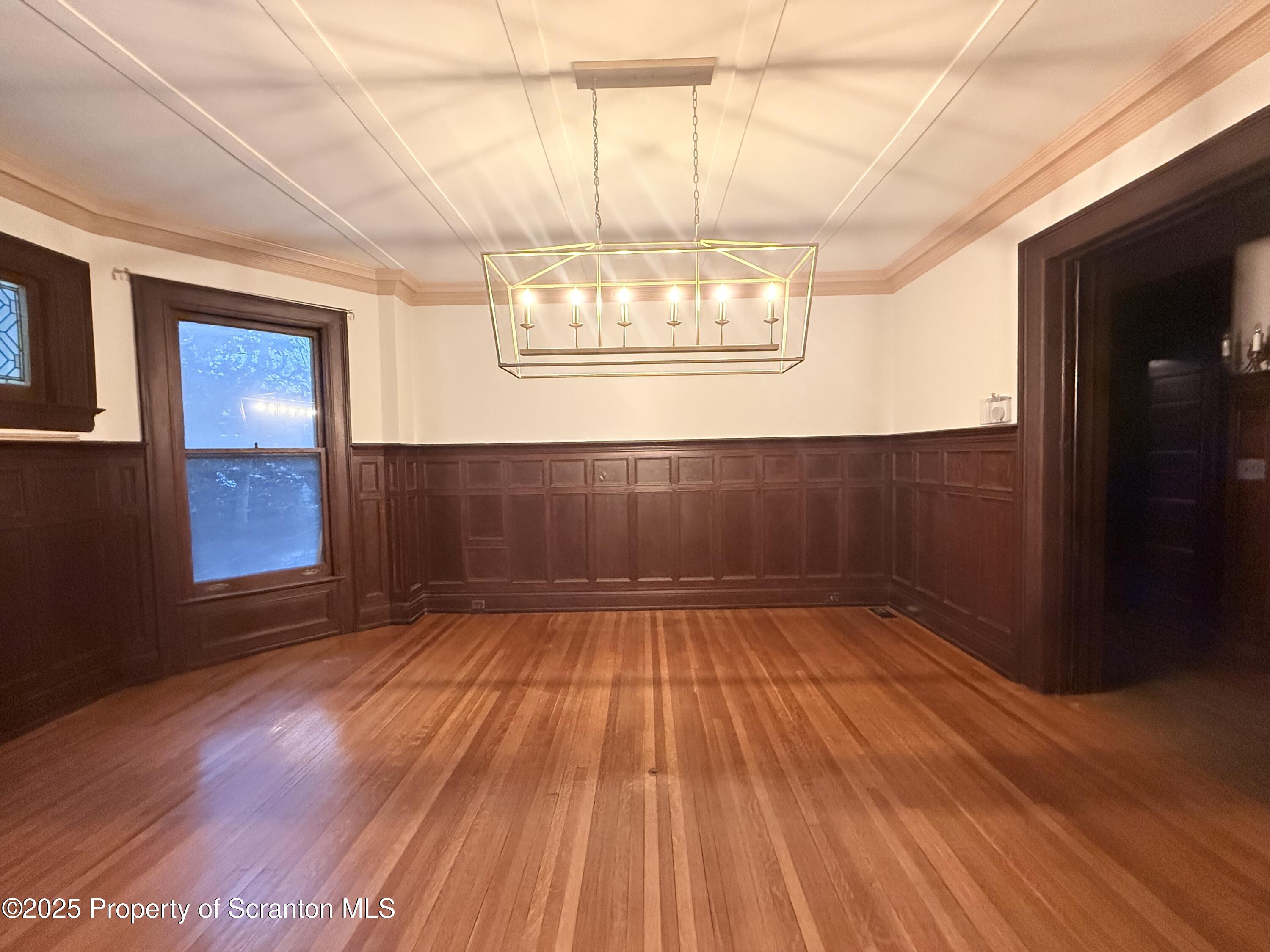 629 Clay Avenue, Unit 1 Scranton, PA 18510 - Photo 4 of 15 a view of an empty room with wooden floor and a window