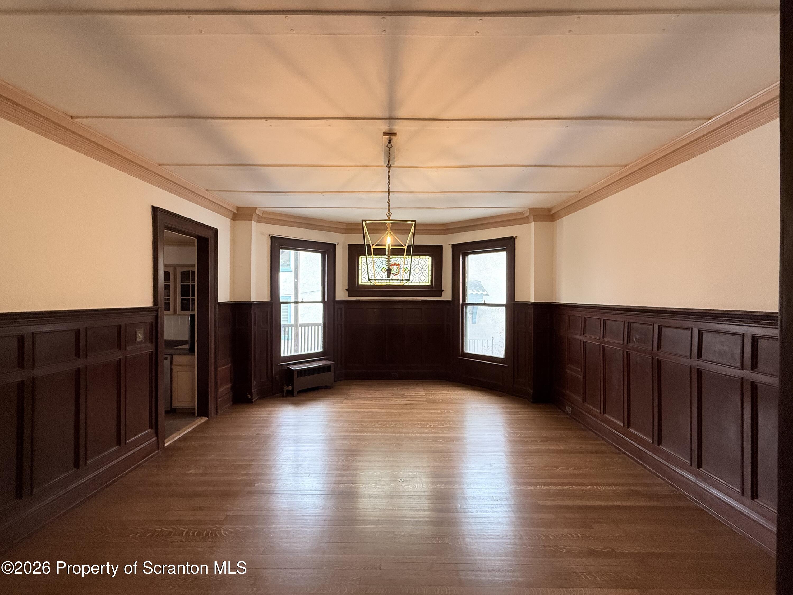 629 Clay Avenue, Unit 1 Scranton, PA 18510 - Photo 6 of 15 an empty room with wooden floor and windows