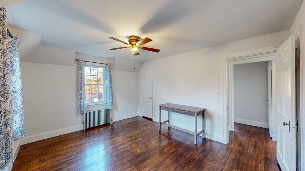 8 Samoset Road Dedham, MA 02026 - Photo 13 of 35 a view of an empty room with a window and wooden floor