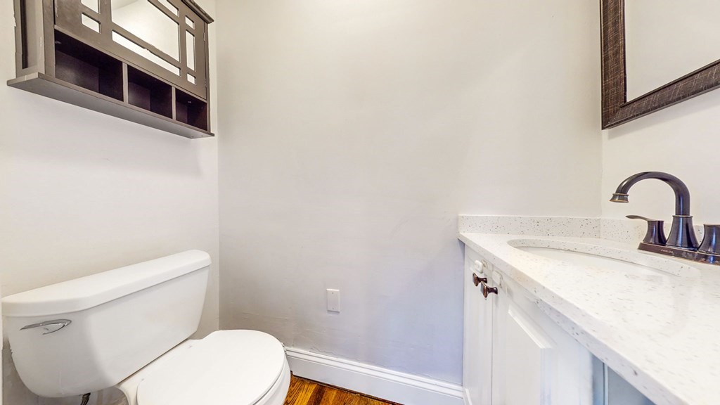 8 Samoset Road Dedham, MA 02026 - Photo 17 of 35 a bathroom with a toilet sink and mirror
