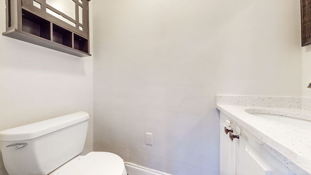 8 Samoset Road Dedham, MA 02026 - Photo 18 of 35 a white toilet sitting next to a white sink