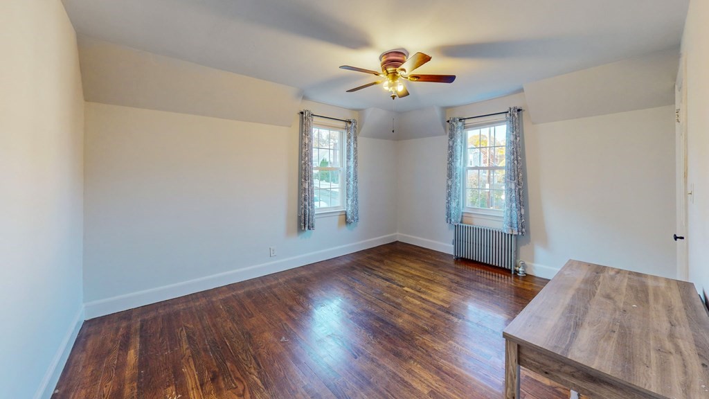 8 Samoset Road Dedham, MA 02026 - Photo 19 of 35 a view of an empty room with wooden floor and a window