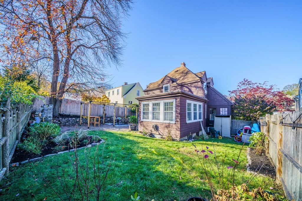 8 Samoset Road Dedham, MA 02026 - Photo 23 of 35 a front view of a house with a big yard potted plants and large tree