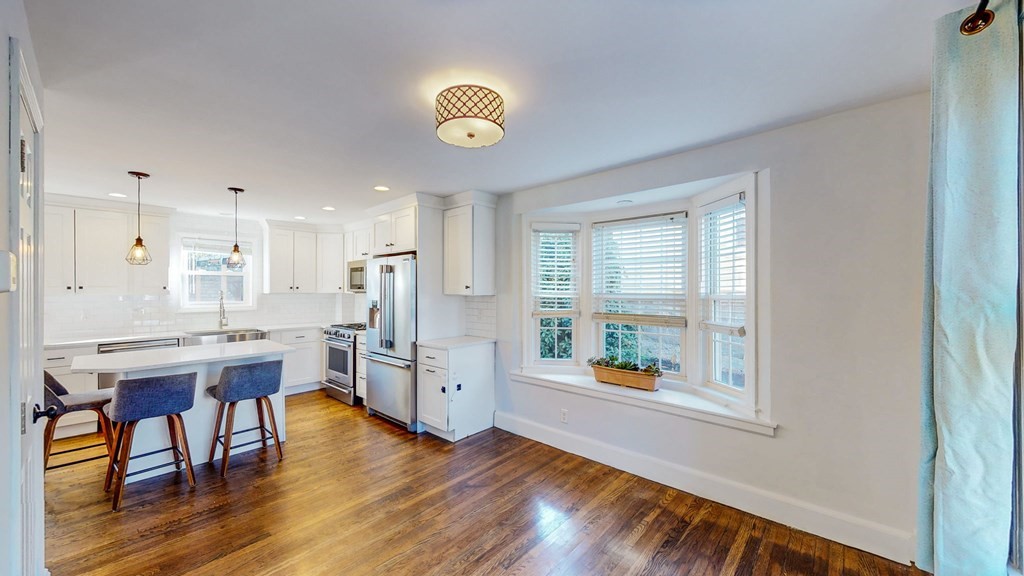 8 Samoset Road Dedham, MA 02026 - Photo 27 of 35 a living room with stainless steel appliances kitchen island granite countertop furniture and a wooden floor