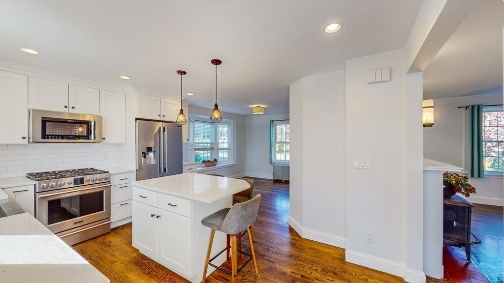 8 Samoset Road Dedham, MA 02026 - Photo 4 of 35 a kitchen with stainless steel appliances a stove a refrigerator and a oven with wooden floor