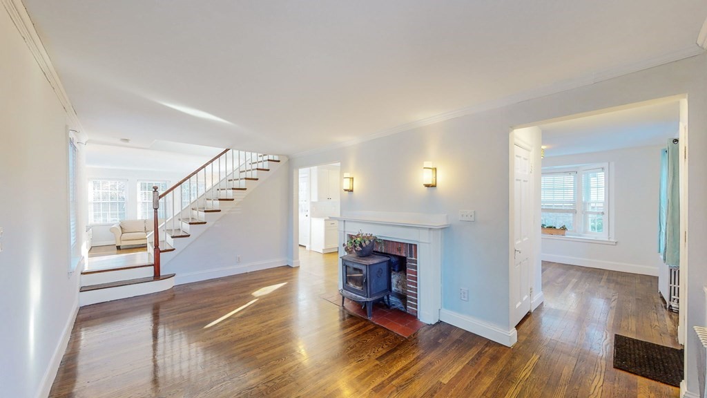 8 Samoset Road Dedham, MA 02026 - Photo 6 of 35 a view of empty room with wooden floor and fireplace