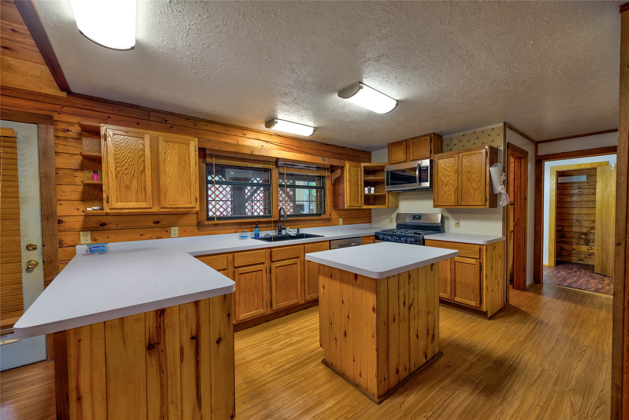 290 Armadillo Road Trinity, TX 75862 - Photo 15 of 28 a kitchen with stainless steel appliances granite countertop sink stove top oven and cabinets