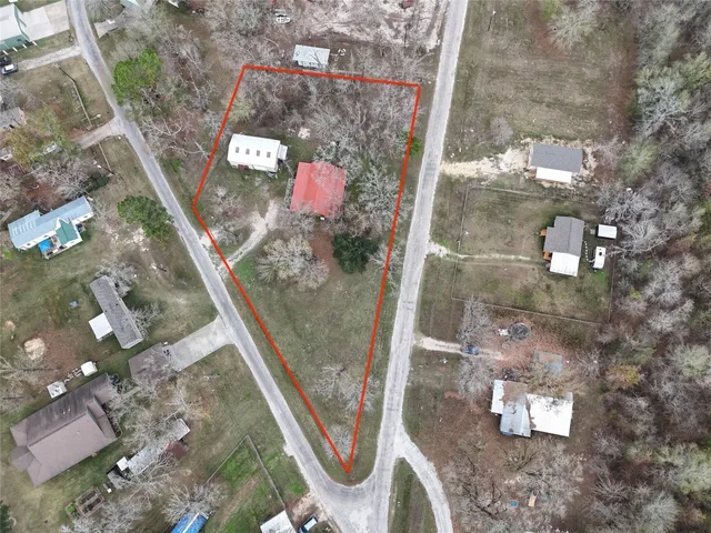 an aerial view of a house with outdoor space