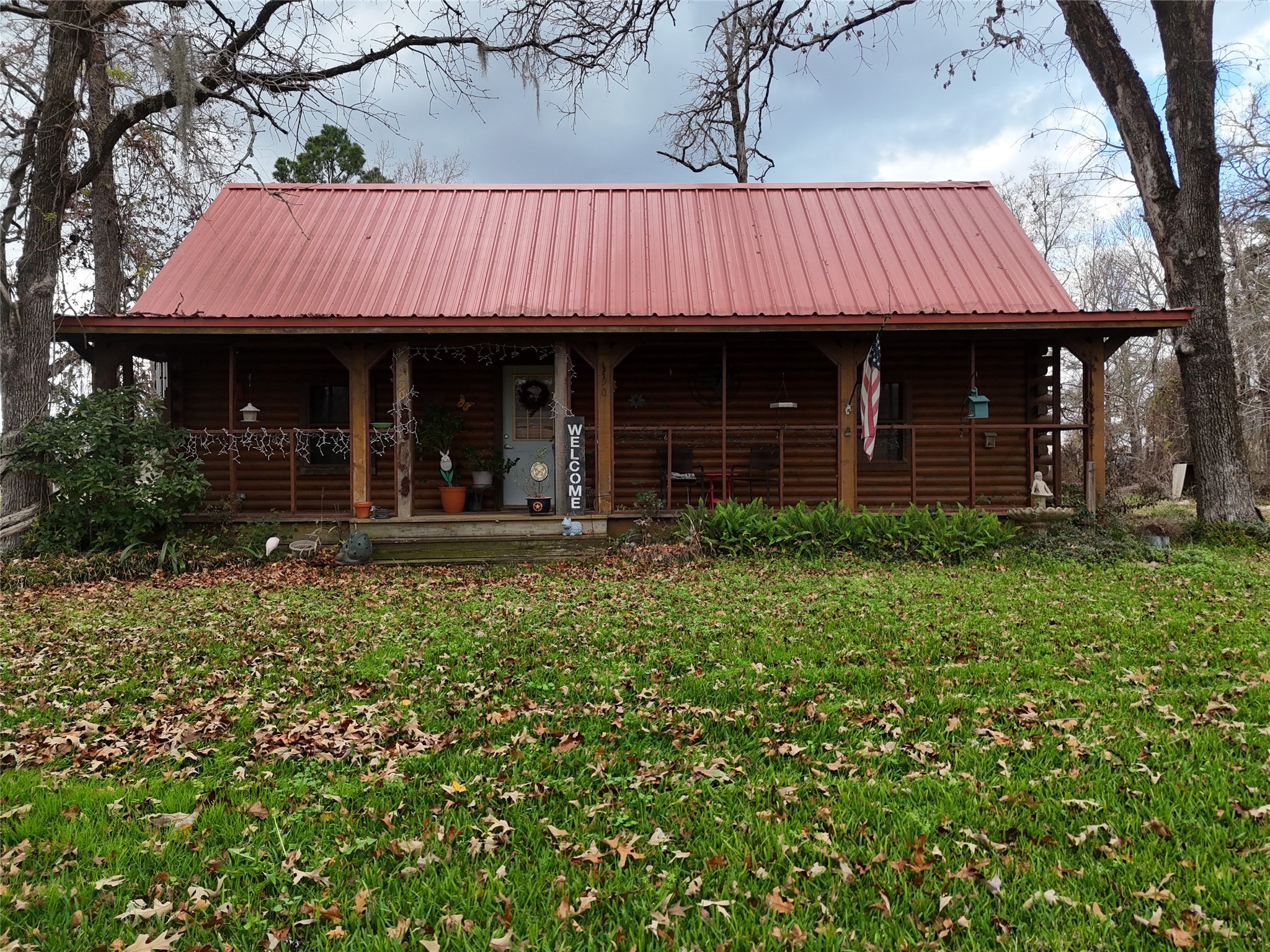 290 Armadillo Road Trinity, TX 75862 - Photo 6 of 28 a view of a brick house with many windows and a yard