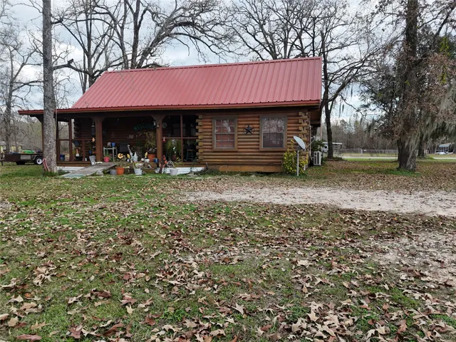 a house with green field in front of it