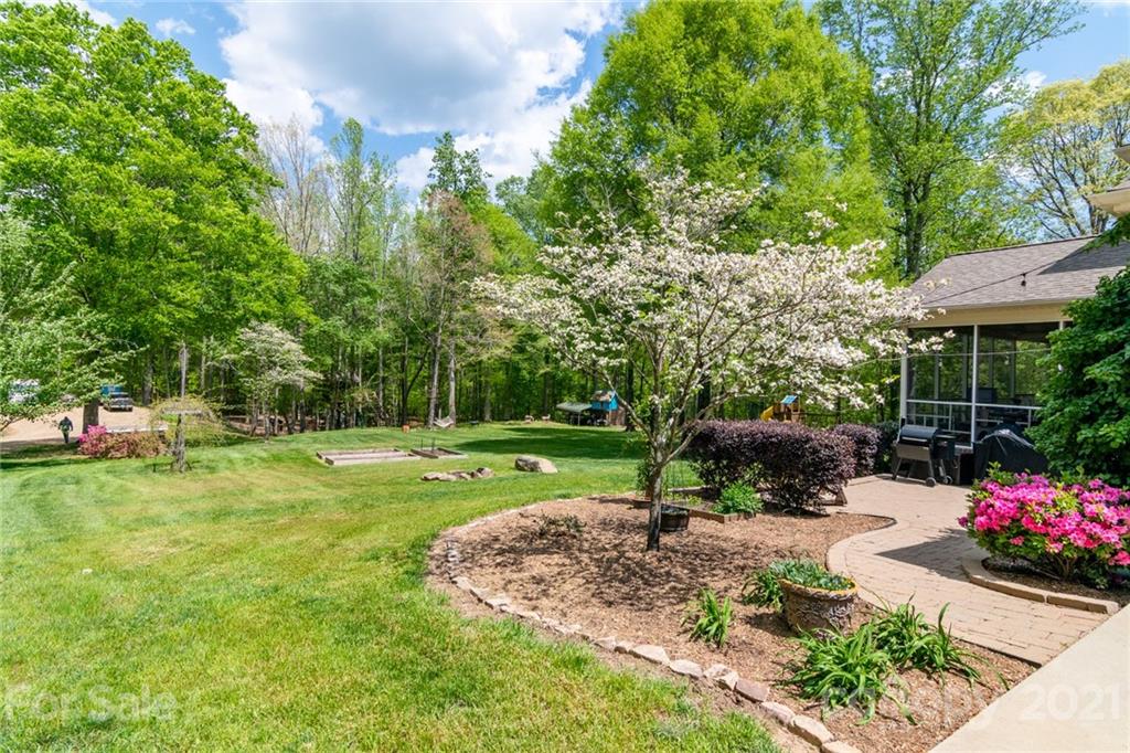 5103 King Wilkinson Road Denver, NC 28037 - Photo 3 of 48 a view of a garden with a bench in a garden