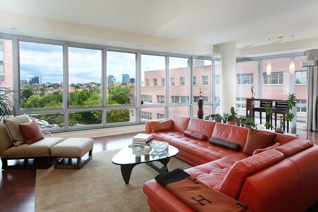 a living room with furniture and a floor to ceiling window