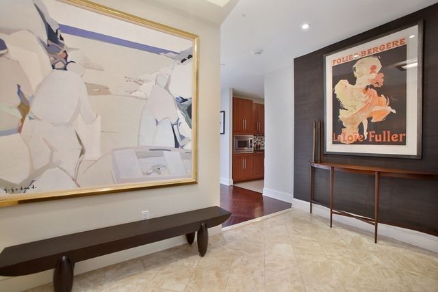 a view of a hallway with paintings on the wall