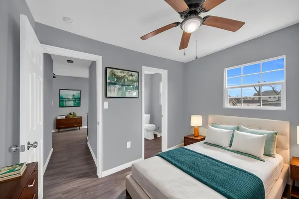 a bedroom with a bed and a chandelier