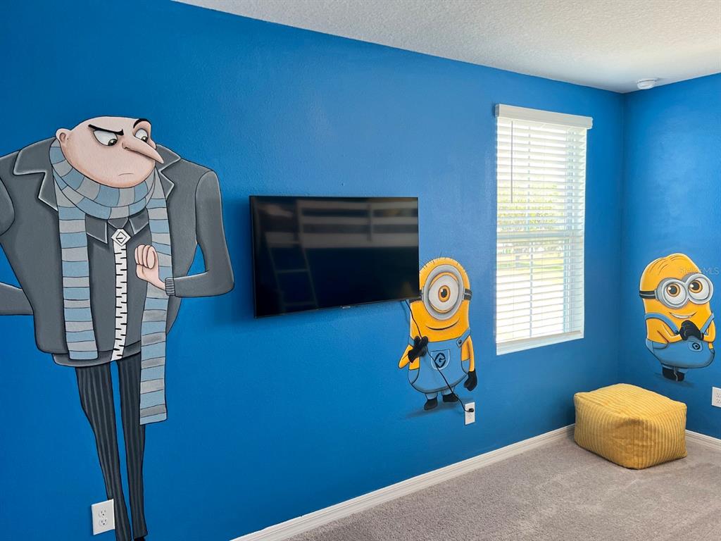 955 Conch Road Davenport, FL 33896 - Photo 12 of 20 a bedroom with a bed and a chandelier