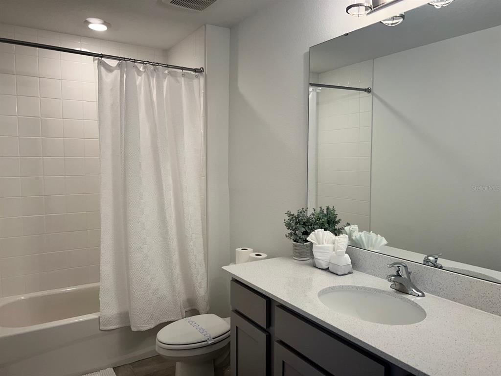 955 Conch Road Davenport, FL 33896 - Photo 13 of 20 a bathroom with a sink toilet and shower