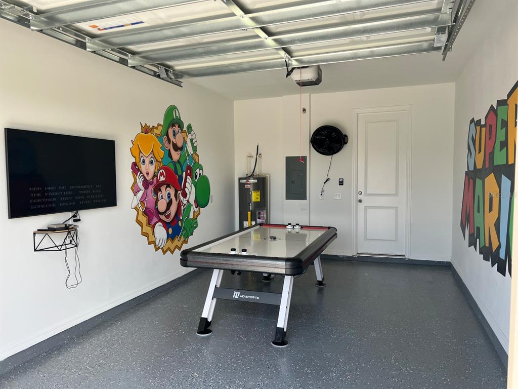 955 Conch Road Davenport, FL 33896 - Photo 14 of 20 a view of a workspace with furniture and a flat screen tv