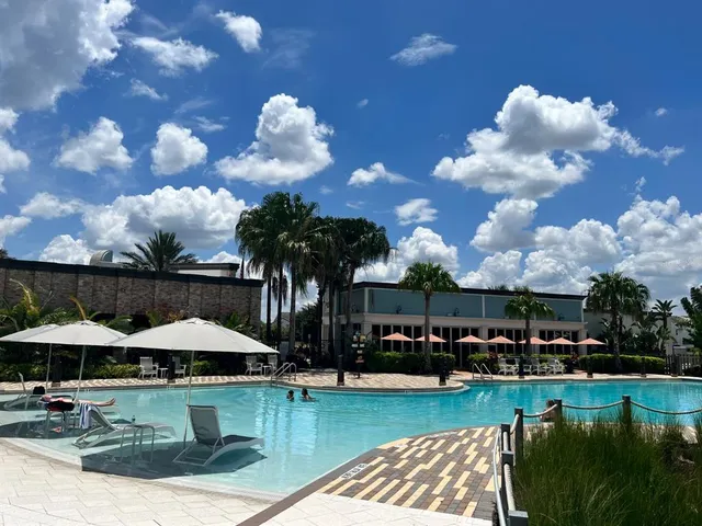 a view of a swimming pool and lounge chairs in patio
