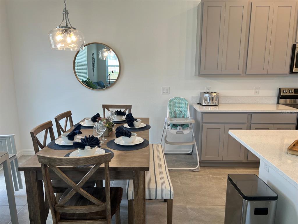 955 Conch Road Davenport, FL 33896 - Photo 3 of 20 a view of a dining room with furniture and chandelier