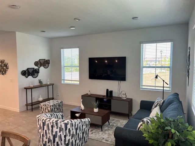 a living room with furniture and a flat screen tv
