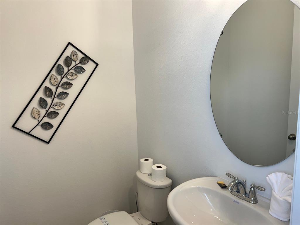 955 Conch Road Davenport, FL 33896 - Photo 6 of 20 a bathroom with a toilet sink and mirror