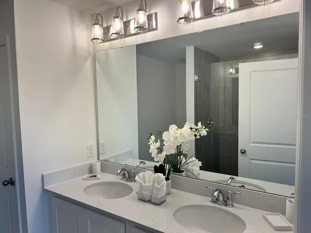 a bathroom with a sink vanity and a mirror