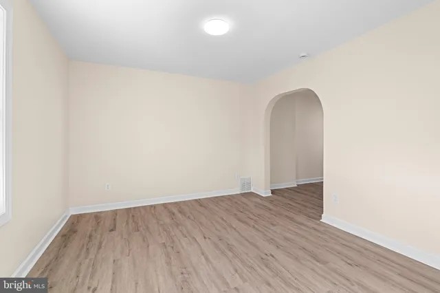 a view of a room with wooden floor and white walls